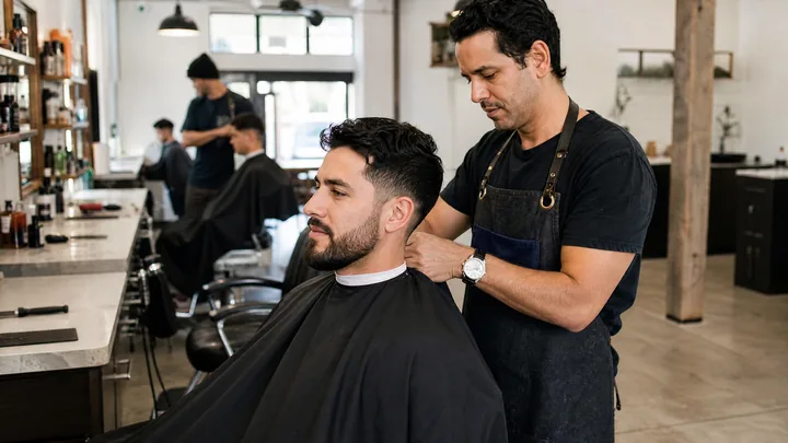 Modern beauty salon client scanning a QR code to pay after an appointment